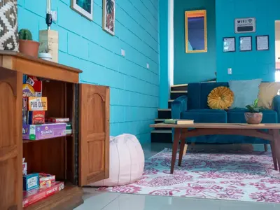 a blue room with a couch and a table at Lolas Hostal Hab Individual 2 Baño Compartido in San José