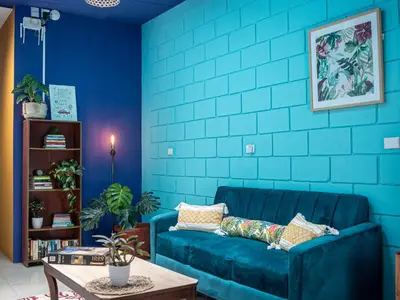 a blue room with a couch and a table at Lolas Hostal Hab Individual 2 Baño Compartido in San José