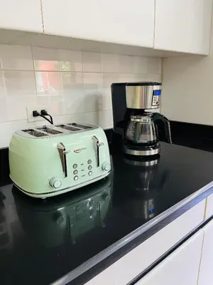 a toaster sitting on top of a kitchen counter at The Rainier Bed & Breakfast 5 in San José