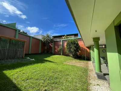 a side view of a house with a yard at The Rainier Bed & Breakfast 5 in San José