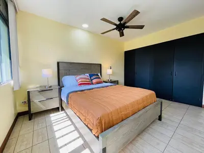 a bedroom with a bed and a ceiling fan at The Rainier Bed & Breakfast 5 in San José