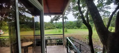 a screened in porch with a view of a field at Casita Maripier in Morado
