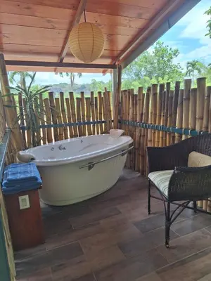 a bath tub in a room with a wooden ceiling at Casita Maripier in Morado