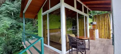 a room with a bed and a table on a patio at Casita Maripier in Morado