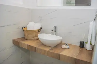 a bathroom with a bowl sink on a wooden counter at The Stay San Jose in San José