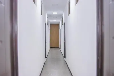 an empty corridor of an office building with white walls at The Stay San Jose in San José