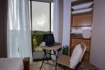 a room with a laptop computer on a table in front of a window at Alma Verde 2 in Monteverde Costa Rica