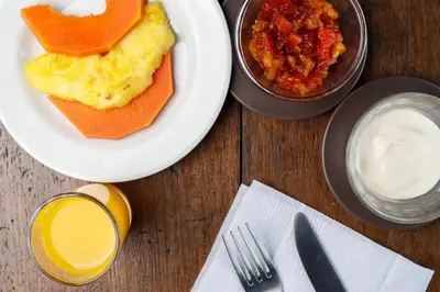 a table with a plate of food with eggs and salsa at Casa Pitahaya in Monteverde Costa Rica