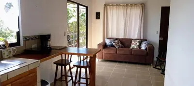 a kitchen and living room with a couch and a table at Casa Pitahaya in Monteverde Costa Rica
