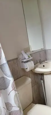 a bathroom with a sink and a toilet and a mirror at Casa Pitahaya in Monteverde Costa Rica