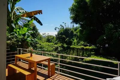 a wooden table and a bench on a balcony at Villa SOL in Santa Teresa Beach