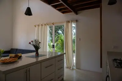 a kitchen with a counter and a large window at Villa SOL in Santa Teresa Beach