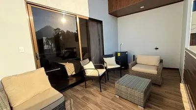 a living room with chairs and a couch and a table at Arenal Monara in Fortuna