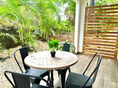 a wooden table with chairs and a potted plant on a patio at Quepos Fishing Villa in Quepos