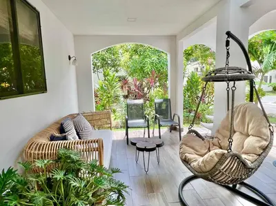 a living room with a couch and chairs at Quepos Fishing Villa in Quepos