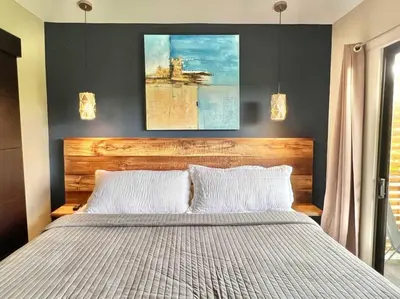 a bedroom with a large bed with two white pillows at Quepos Fishing Villa in Quepos
