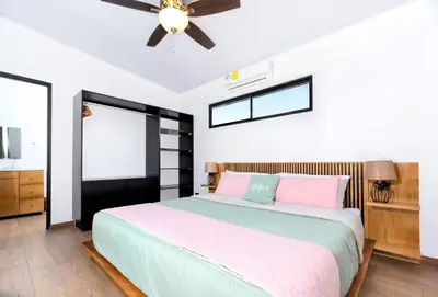 a bedroom with a bed and a ceiling fan at Casa Coral - great location - high speed internet in Uvita
