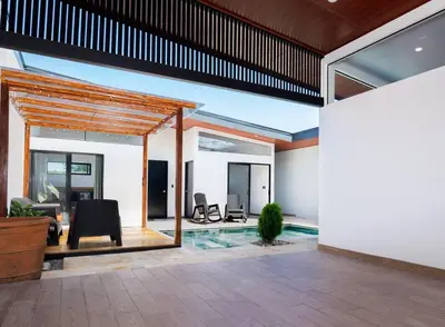 an open living room with chairs and a pool at Casa Coral - great location - high speed internet in Uvita
