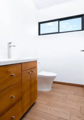 a bathroom with a sink and a toilet and a window at Casa Coral - great location - high speed internet in Uvita