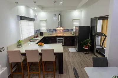 a kitchen with a large white island in a room at Arenal White Bliss Villa in Fortuna