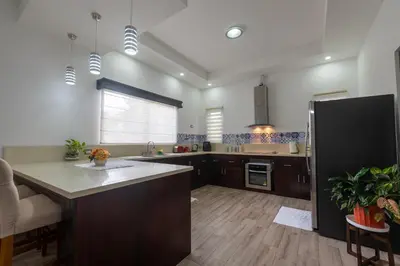 a large kitchen with a large island in the middle at Arenal White Bliss Villa in Fortuna