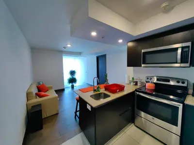 a kitchen with a sink and a stove top oven at 706 Torres Los Yoses Hermoso apartamento en Barrio Escalante con Parqueo in San José