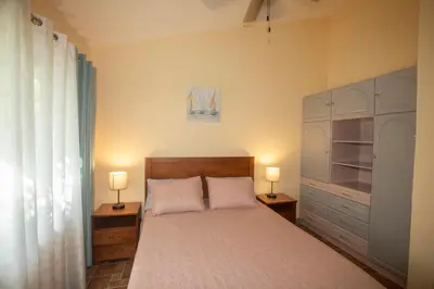 a bedroom with a bed and two lamps on tables at Three Bedroom Sunny Townhome in Coco