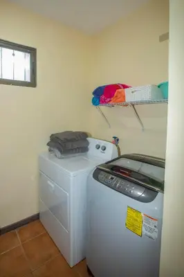 a laundry room with a washing machine and a washer at Three Bedroom Sunny Townhome in Coco