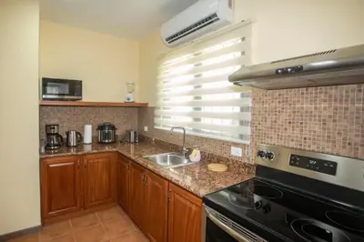 a kitchen with a sink and a stove at Three Bedroom Sunny Townhome in Coco