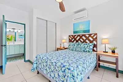 a bedroom with a bed with a blue bedspread at 1-BD Near Beach Great for Digital Nomads in Potrero