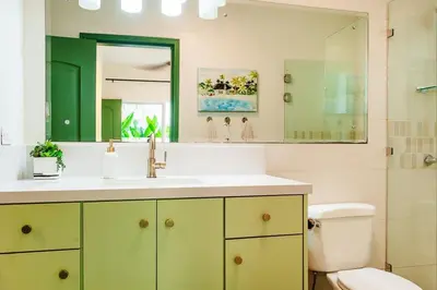 a bathroom with a sink and a toilet and a mirror at 1-BD Near Beach Great for Digital Nomads in Potrero