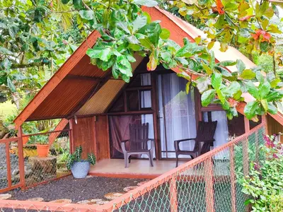 a small house with two chairs and a porch at Villa Campo's in Venecia