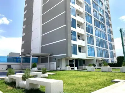 a large building with benches in front of it at 1001 Torres Los Yoses Apartamento con A/C y parqueo full equipado in San José