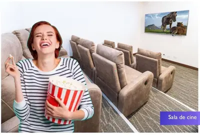 a young woman holding a popcorn in a movie theater at 1001 Torres Los Yoses Apartamento con A/C y parqueo full equipado in San José