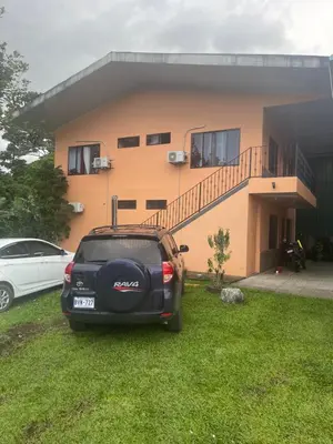 a car parked in front of a house at Sky Hostel in Fortuna
