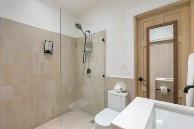 a bathroom with a shower and a toilet and a sink at Modern Garden Villa with Private Pool, Outdoor Kitchen & Separate Casita Near Playa Potrero in Potrero