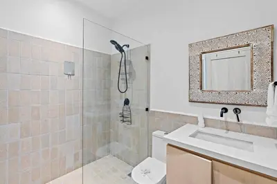 a bathroom with a shower and a sink and a toilet at Modern Garden Villa with Private Pool, Outdoor Kitchen & Separate Casita Near Playa Potrero in Potrero