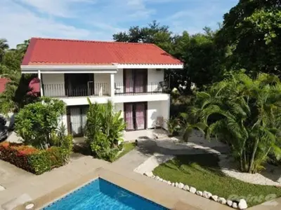 an aerial view of a house with a swimming pool at 2-BD Unit with Pool 2 Blocks from Beach in Coco
