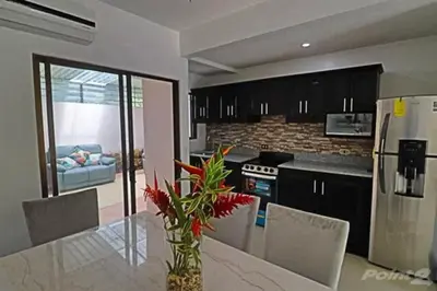 a kitchen with a table with a vase of flowers at 2-BD Unit with Pool 2 Blocks from Beach in Coco