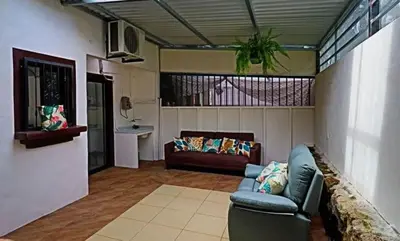 a living room with a couch and a table at 2-BD Unit with Pool 2 Blocks from Beach in Coco
