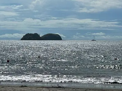 a large body of water with a boat in the distance at Villa Hermosa in Playa Hermosa