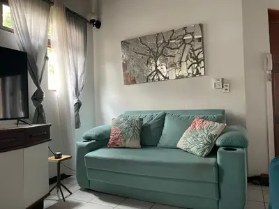 a living room with a blue couch in front of a window at Villa Hermosa in Playa Hermosa