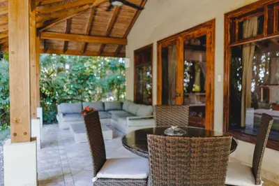 a living room with a table and chairs at Playa Cielo Beachfront Hotel - Santa Teresa, Costa Rica in Santa Teresa Beach