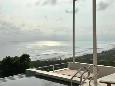 a view of the ocean from the balcony of a house at Les Roches - Paradise Retreat in Santa Teresa Beach