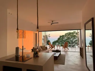 a living room with a view of the ocean at Les Roches - Paradise Retreat in Santa Teresa Beach