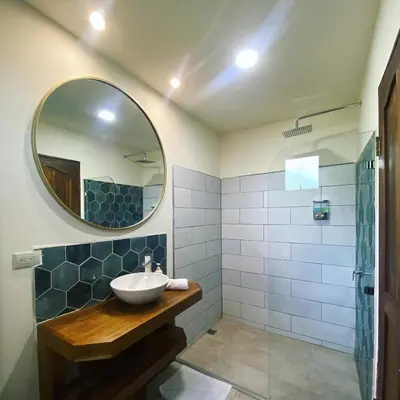 a bathroom with a sink and a mirror at Oasis by Franklin Hotel Boutique in Fortuna