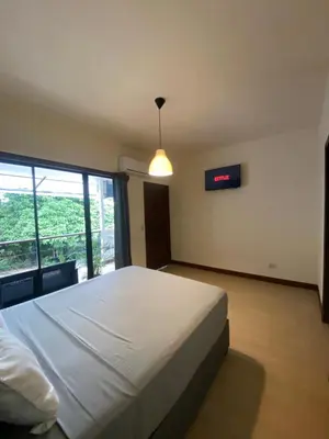 a bedroom with a large white bed and a window at Oasis by Franklin Hotel Boutique in Fortuna