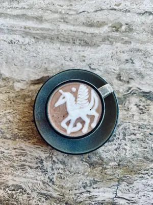 a cup of coffee with a white horse on it at Silvestre Nosara Hotel & Residences in Nosara