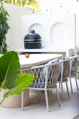 a table and chairs on a patio with plants at Silvestre Nosara Hotel & Residences in Nosara