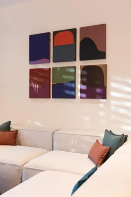 a room with two couches and paintings on the wall at Silvestre Nosara Hotel & Residences in Nosara